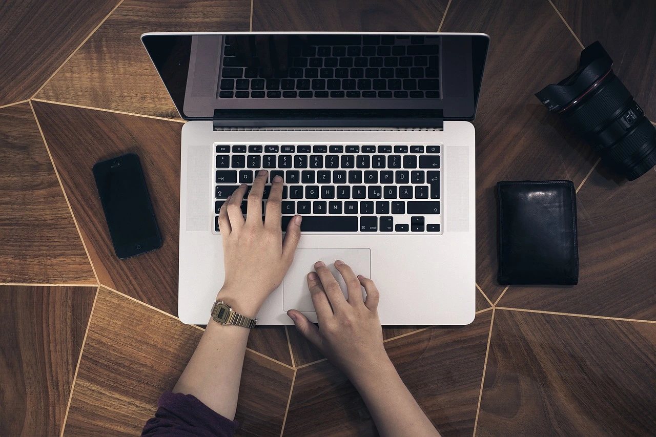 person typing on a laptop